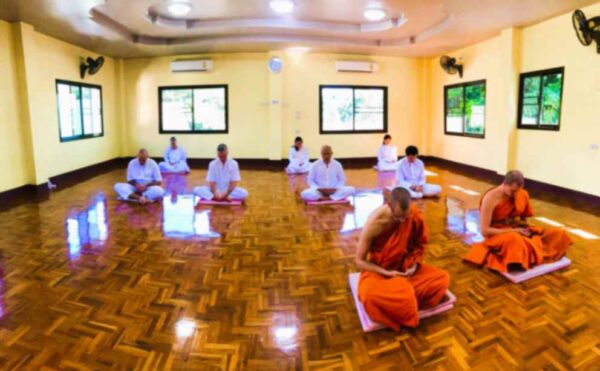 Meditators are doing sitting meditation at the Vipassana Meditation Center at Wat Chom Tong